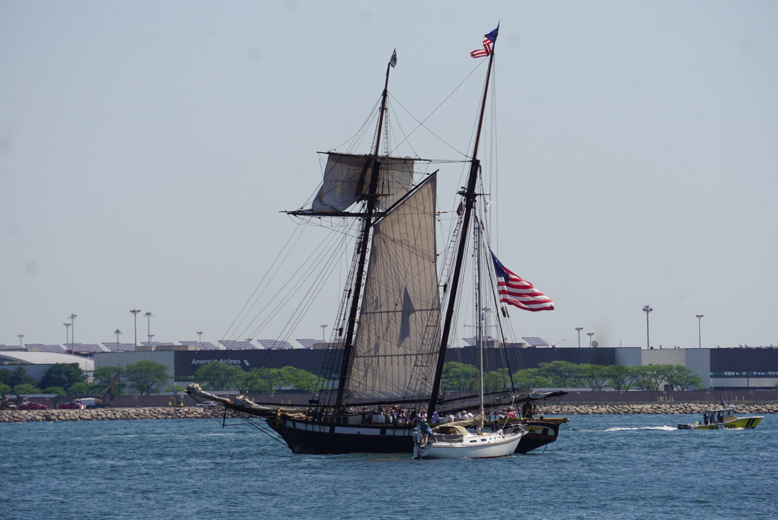 A schooner heeling under working sail in Boston Harbor